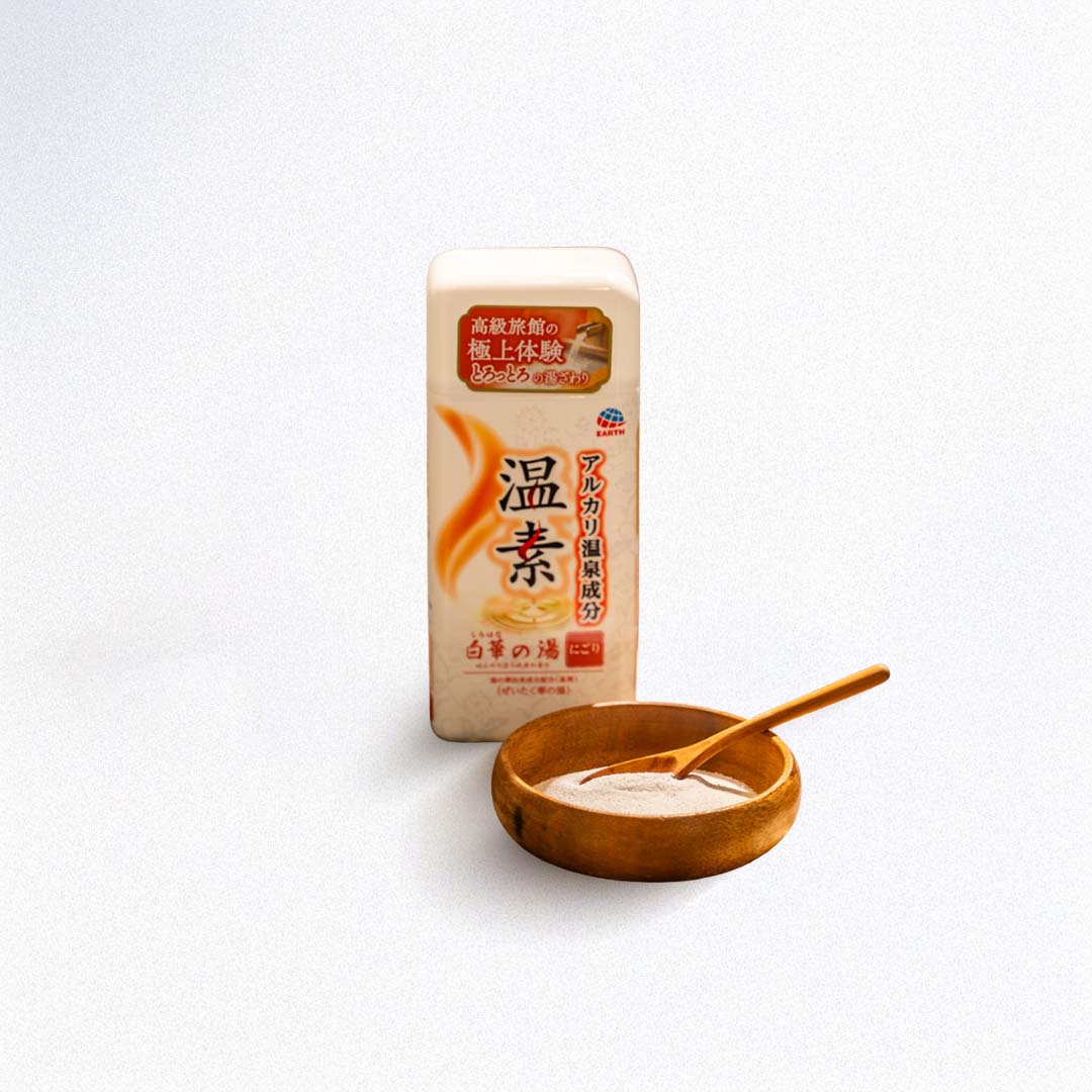 White bath salts with wooden bowl and spoon on a white background