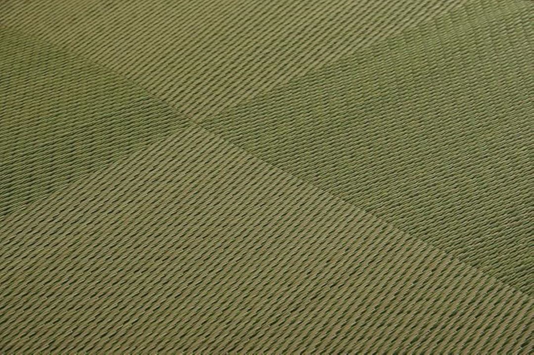 A close-up image of the detailed texture of a Japanese igusa mat, showing the natural weave pattern in shades of green.