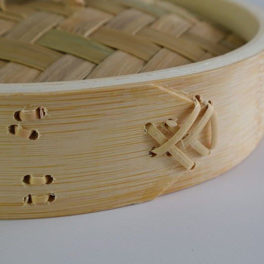 Close-up detail of rattan fasteners securing the bamboo side of a seiro steam basket, showcasing the craftsmanship.
