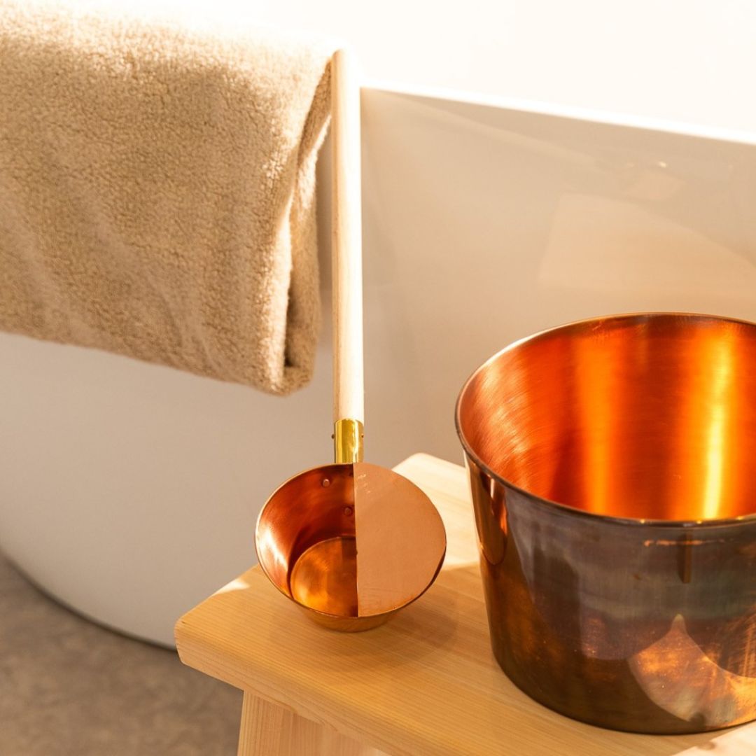 Japanese copper sauna ladle displayed alongside a copper bucket, perfect for a traditional sauna experience.
