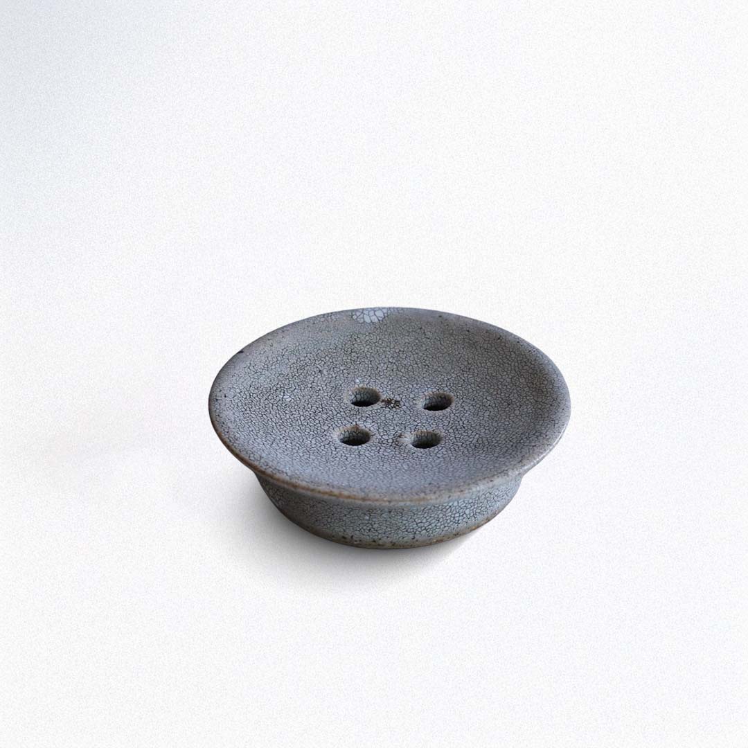 Ceramic soap dish with textured surface on a white background