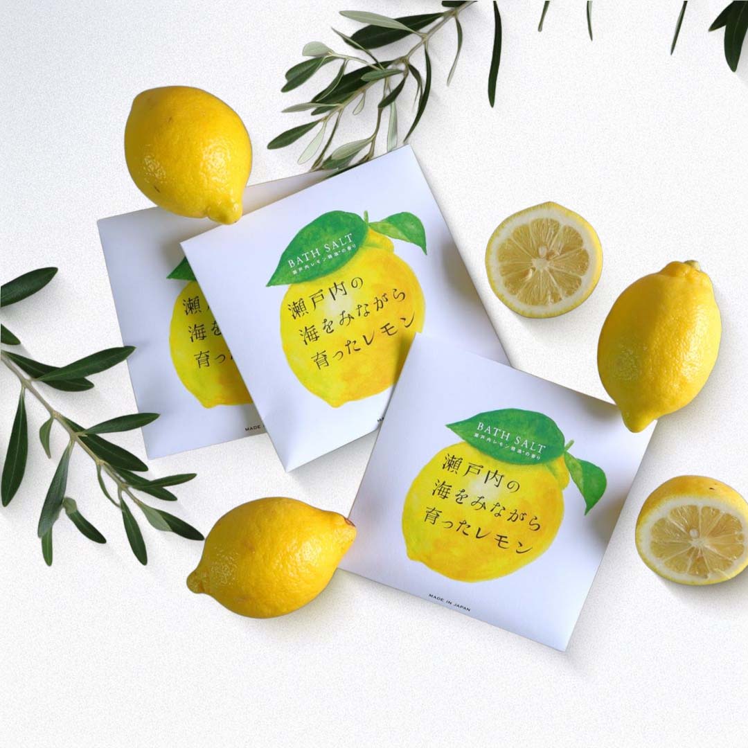 Bath salt packages with lemons and olive branches on a white background