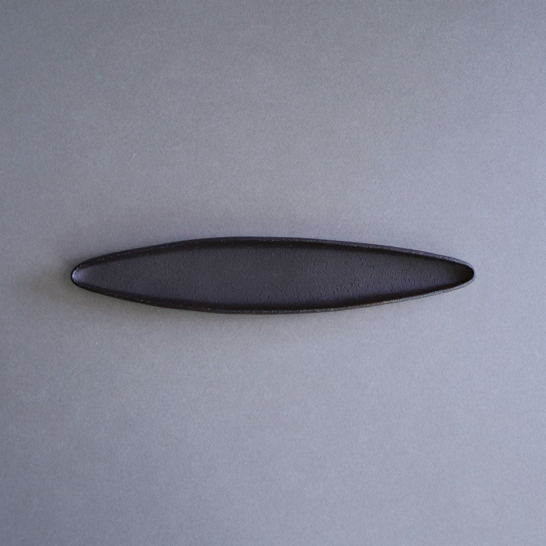 Black oval object on a gray background