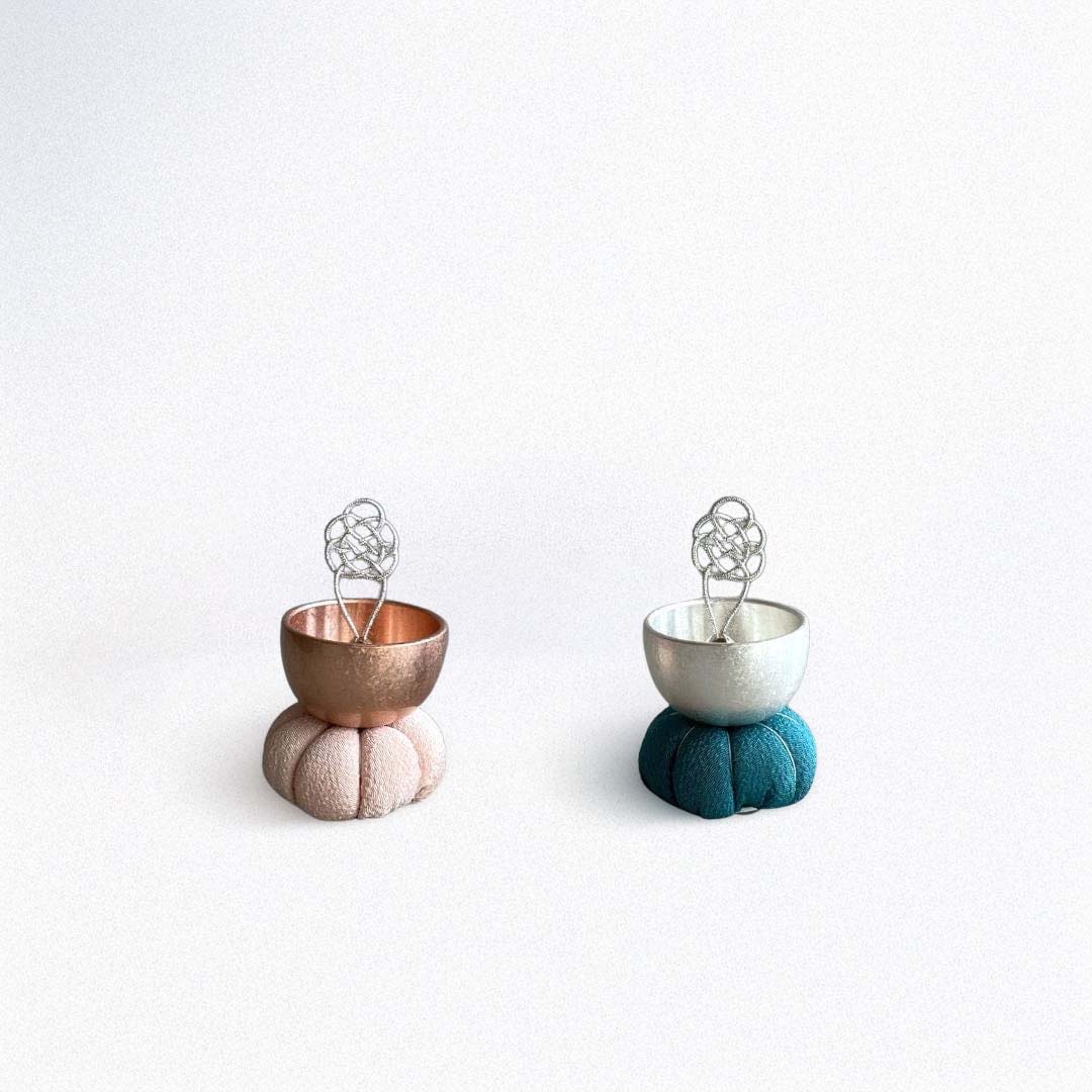 Two singing bell one pink color and a blue one