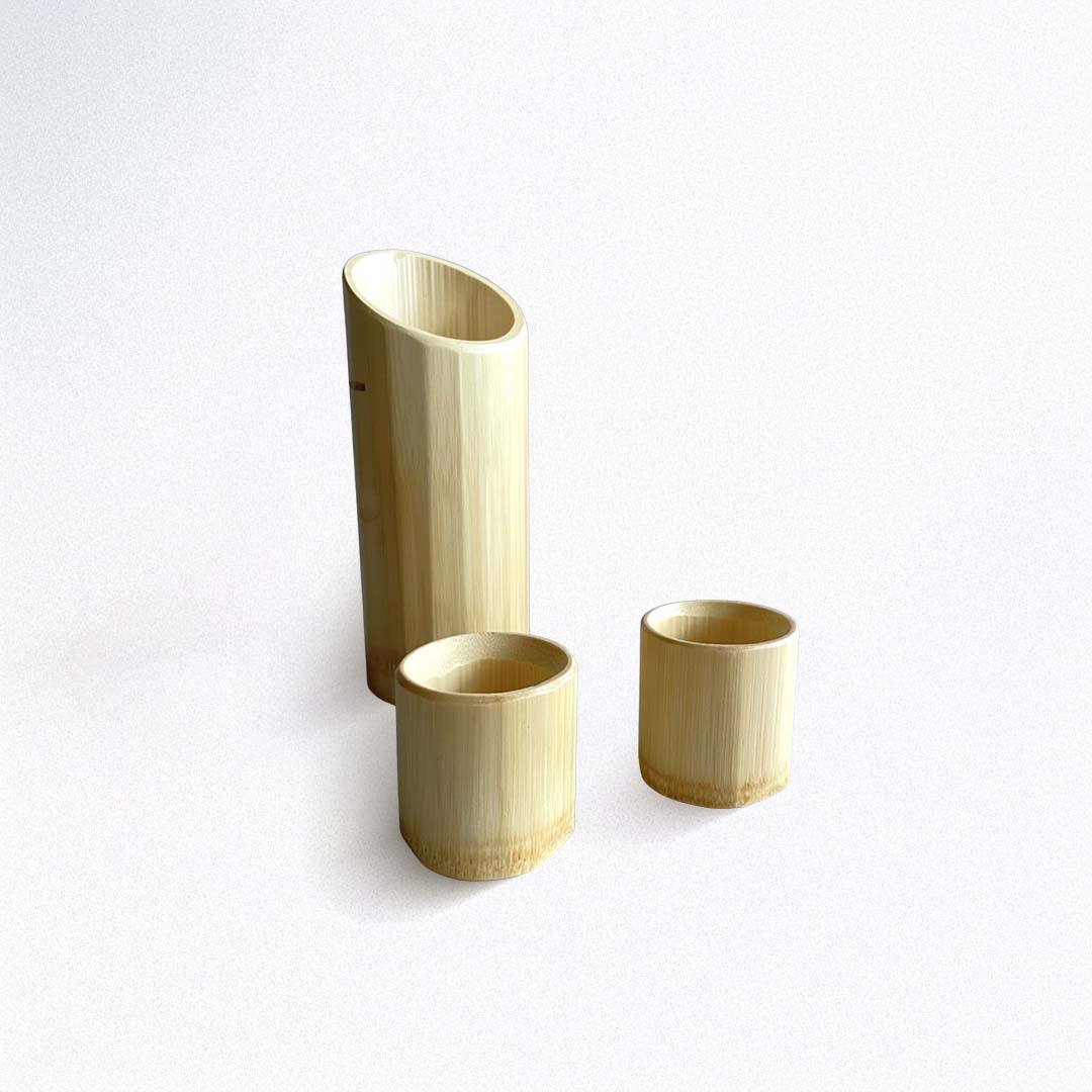 Set of three bamboo sake cups on a white background