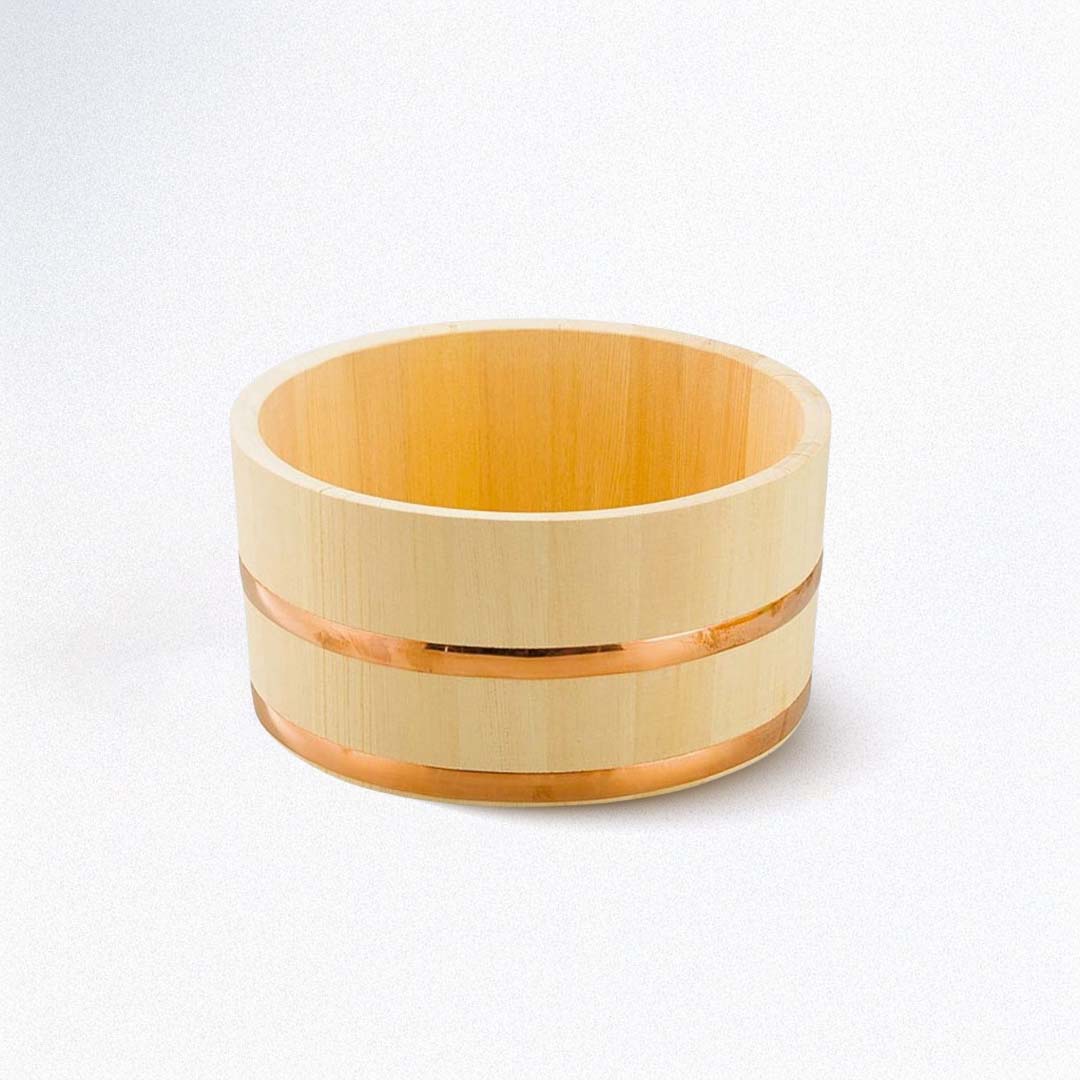 A wooden bath bucket with two copper rings on a white background