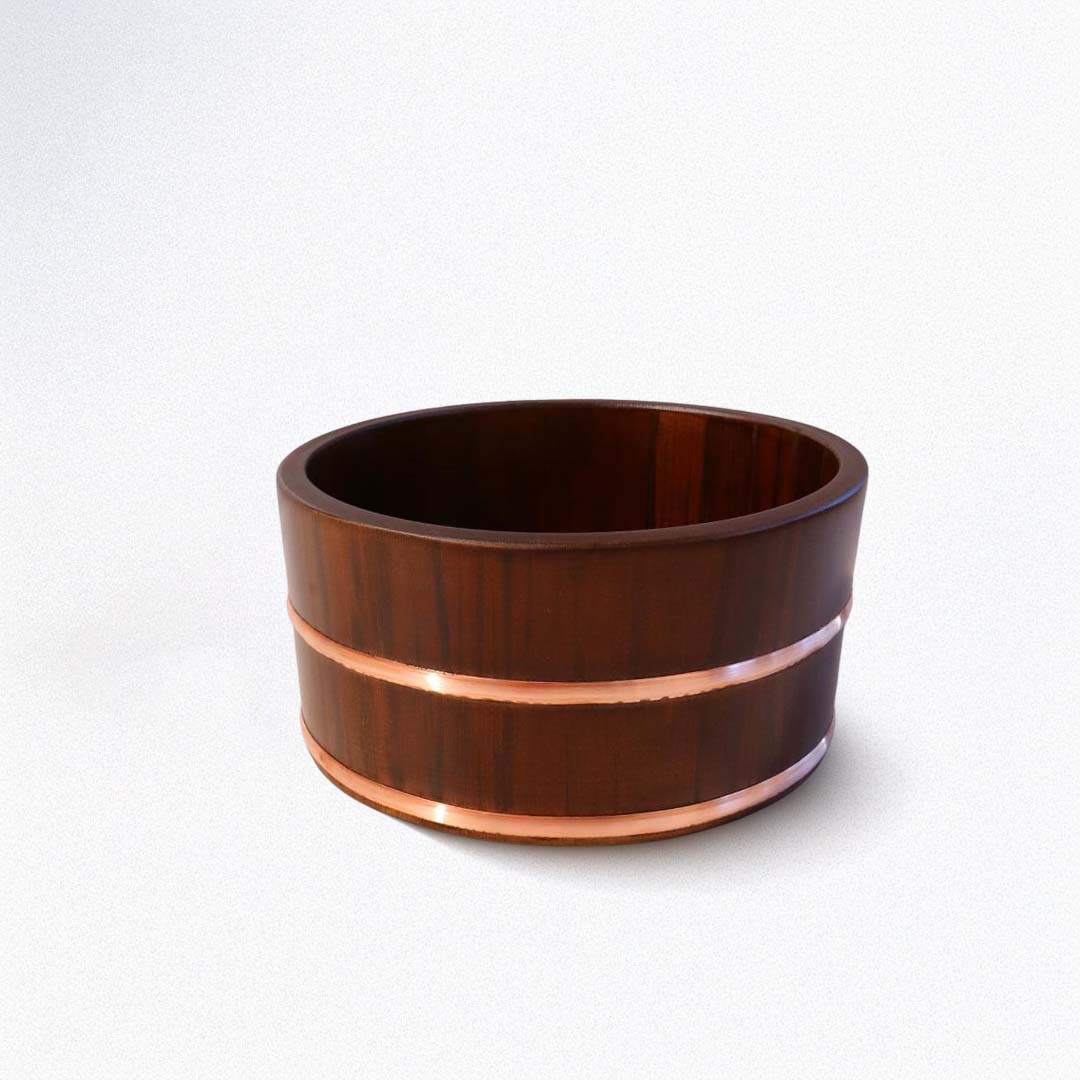 Wooden bucket with copper band on a white background