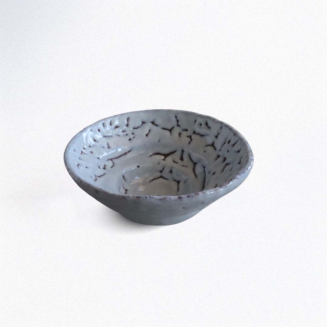 Gray ceramic bowl with textured surface on a white background