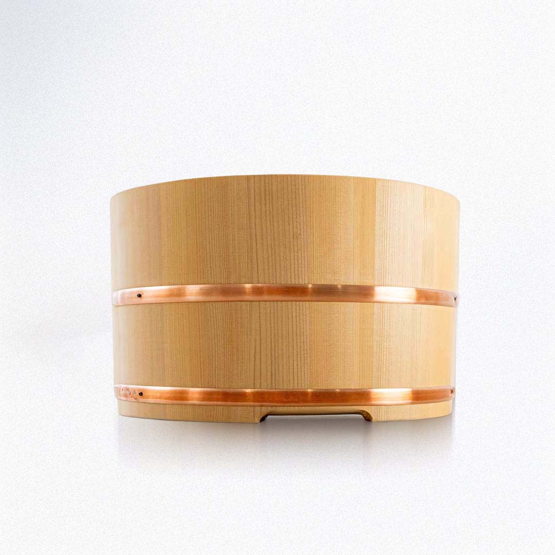 Wooden barrel with copper banding on a white background