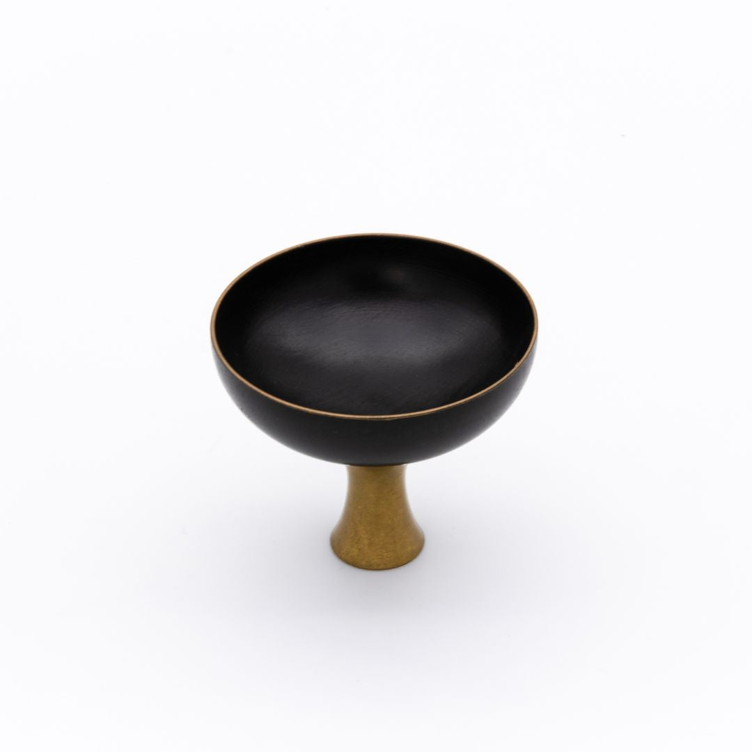 Black Sake cup with a gold base on a white background