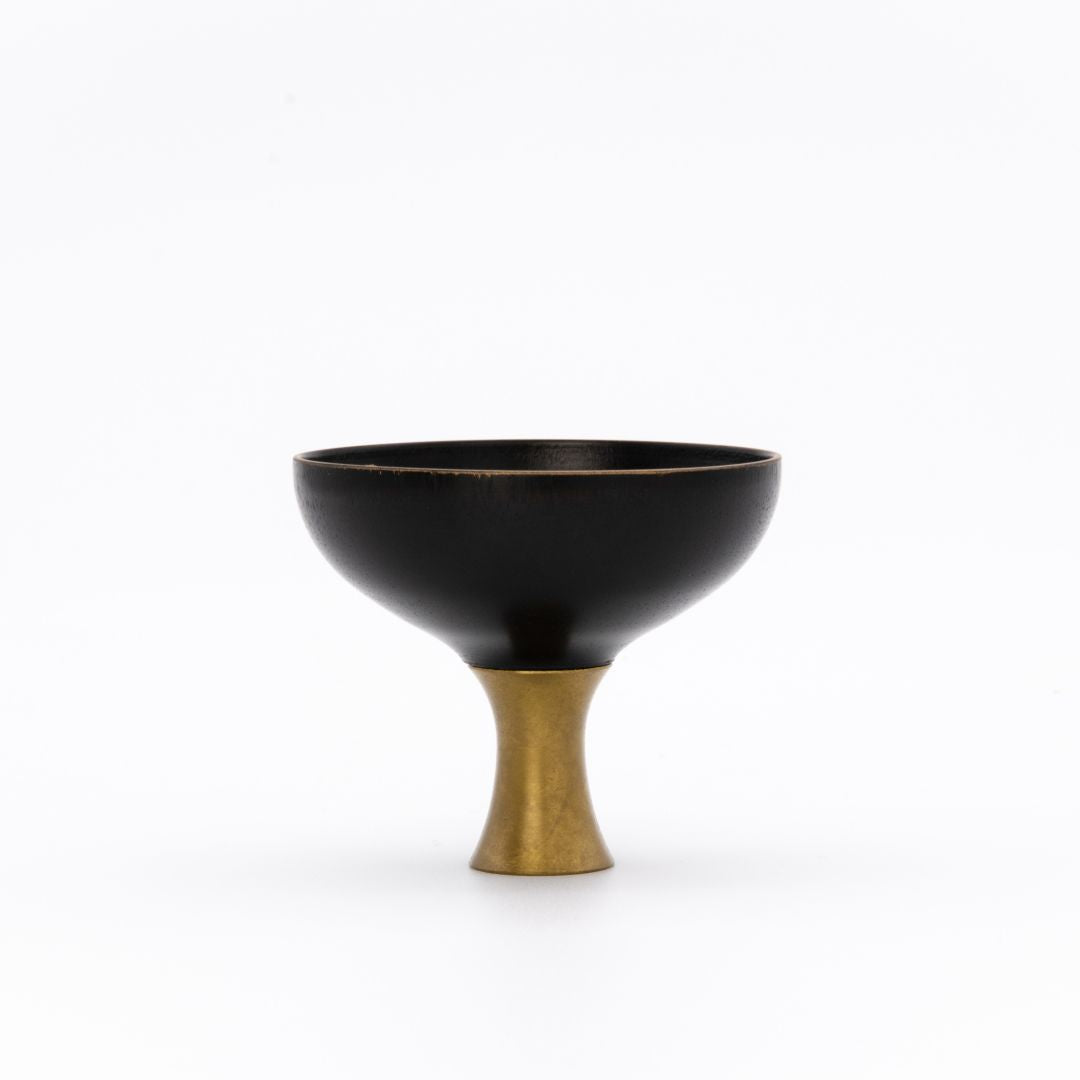 Black Sake cup with a gold base on a white background