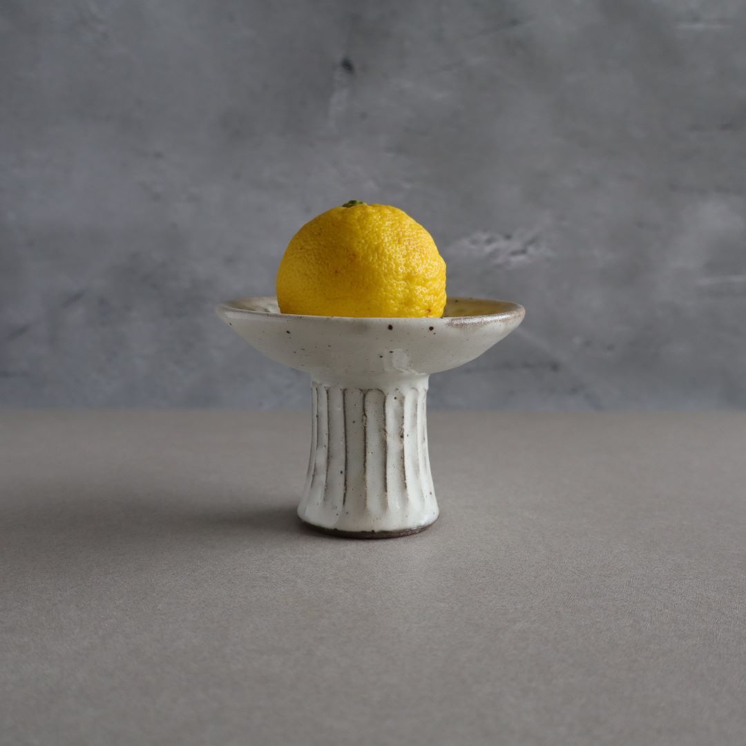 a saucer plate with a lemon on the top