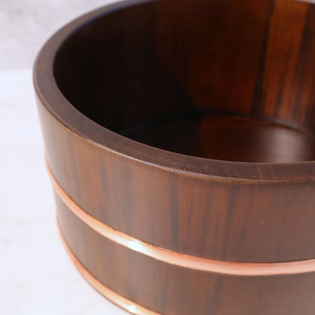 Close-up of a wooden bowl with a focus on its texture and grain.