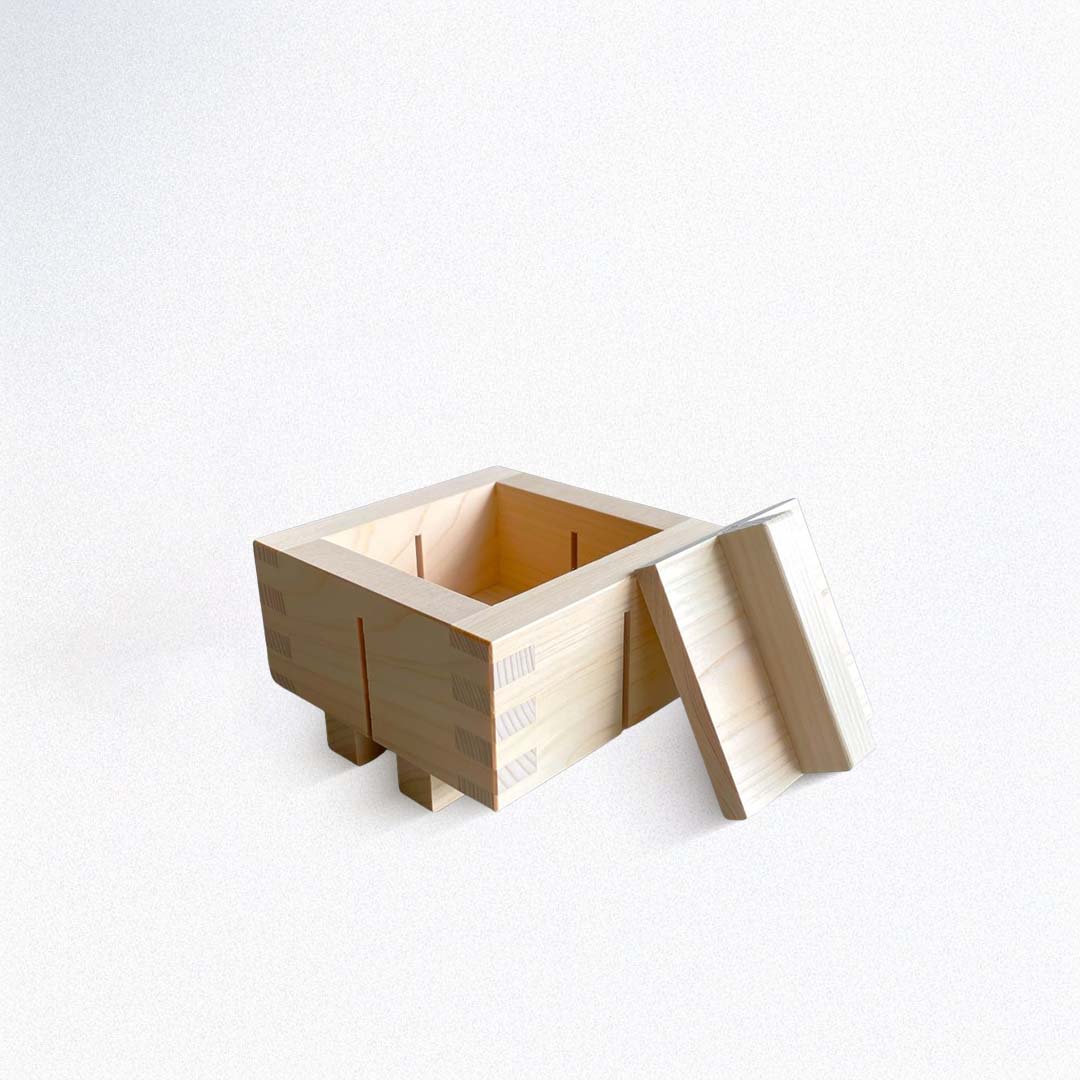 Wooden sushi square with a lid on a white background