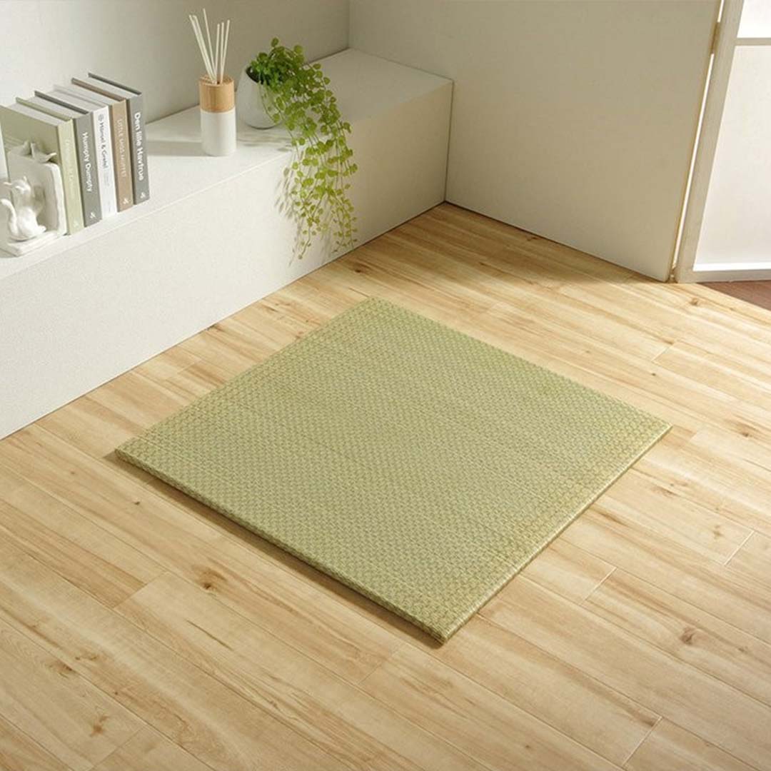 Green rug tatami on a wooden floor with a minimalistic background