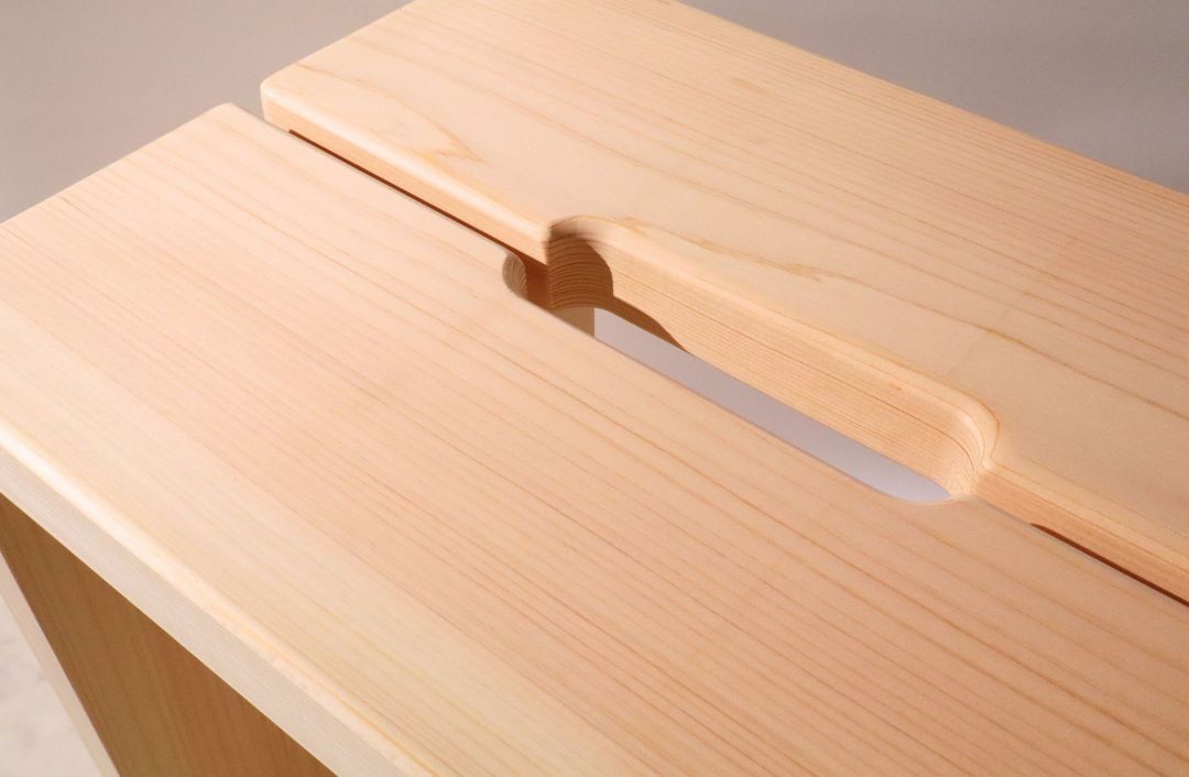 Wooden cutting board with a knife slot on a light background
