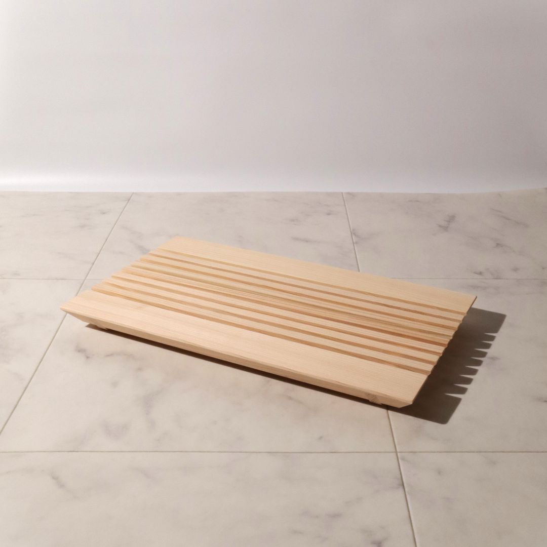 Wooden step stool on a tiled floor