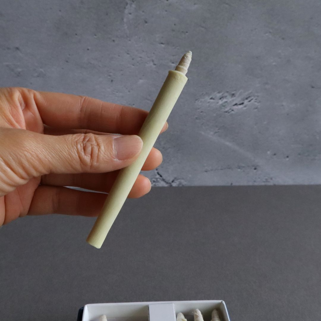 hand holding a wax candle