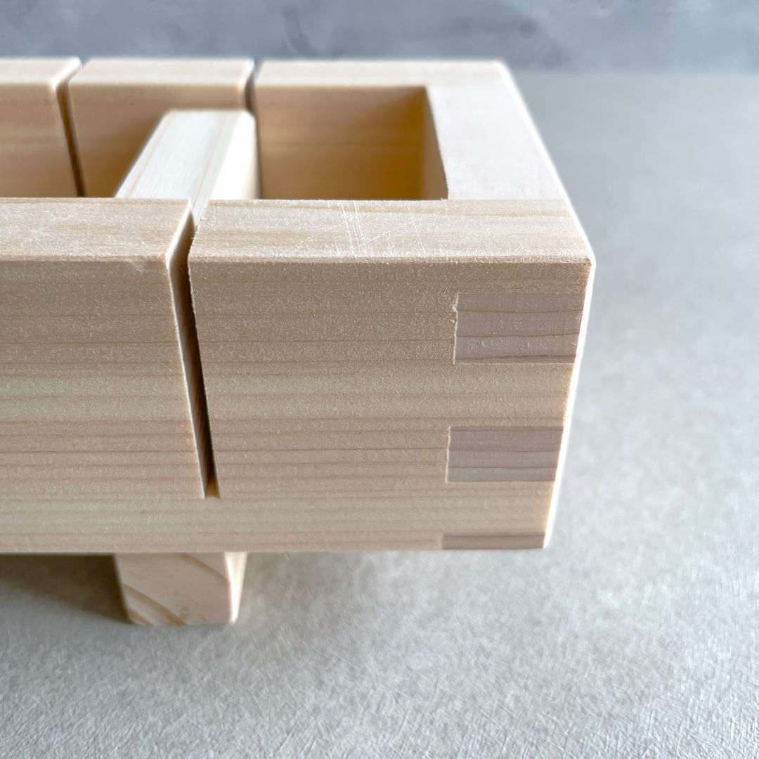 A close view of a wooden sushi box