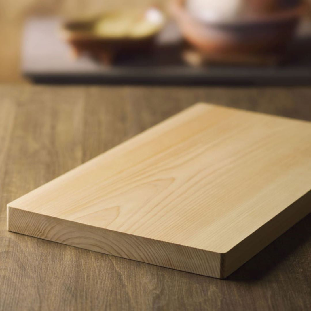 A wooden cutting board on a wood table