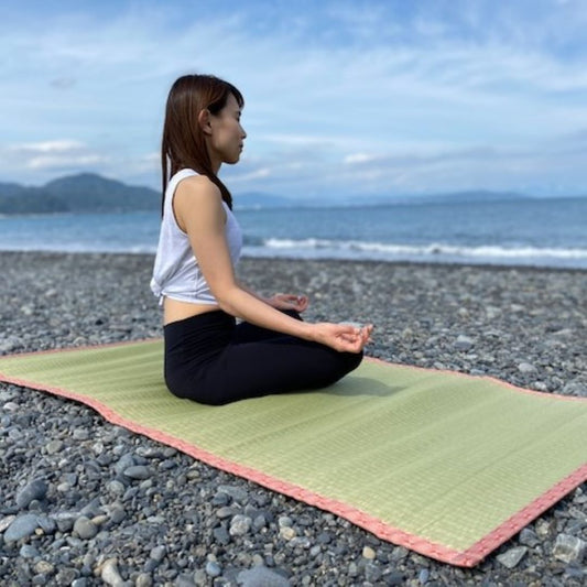 woman practicing yoga on a tatami mat