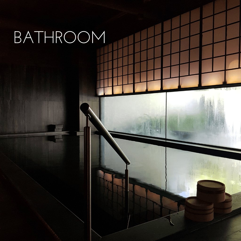 traditional and modern japanese bathroom with plants and a big white bath