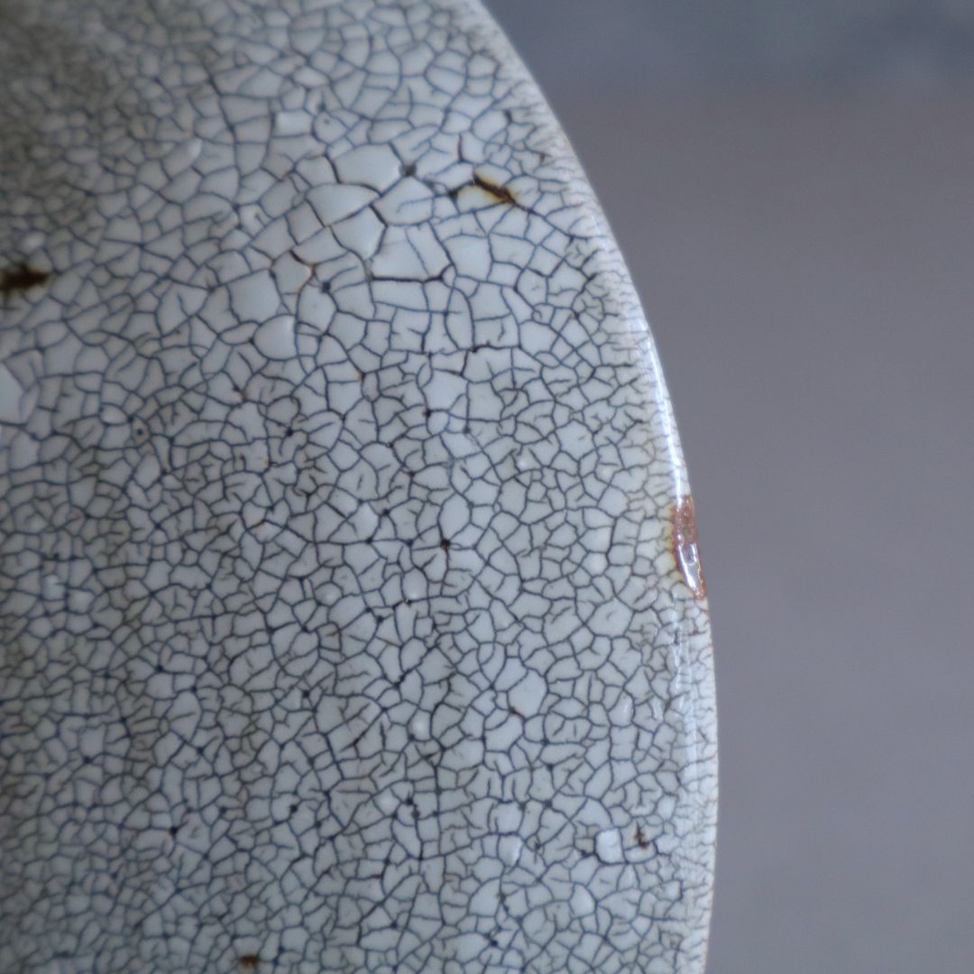 Detailed view of the fine crackled kairagi glaze pattern on the ceramic surface.