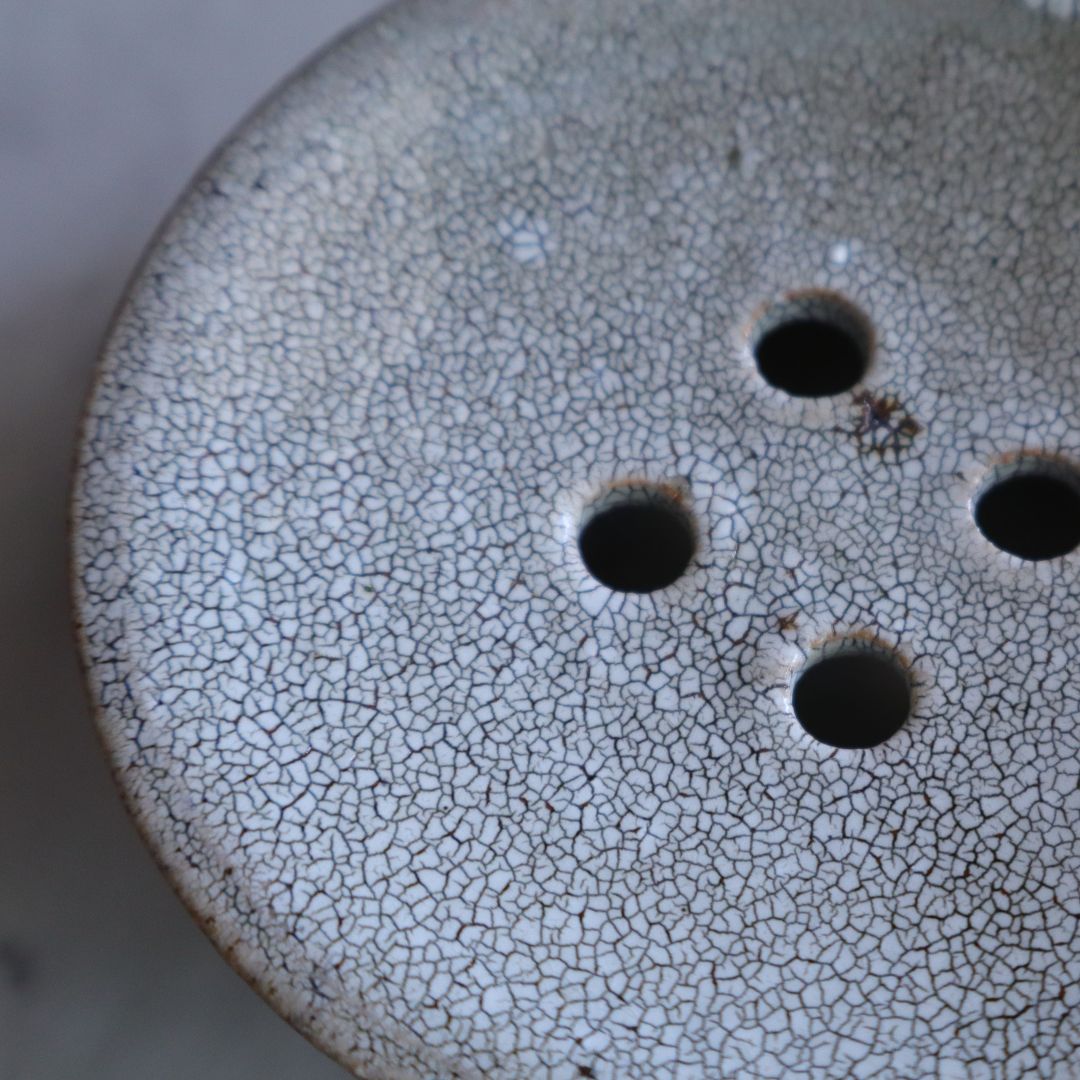Detailed close-up of the soap dish surface showcasing the fine, organic crackled texture of the kairagi glaze

