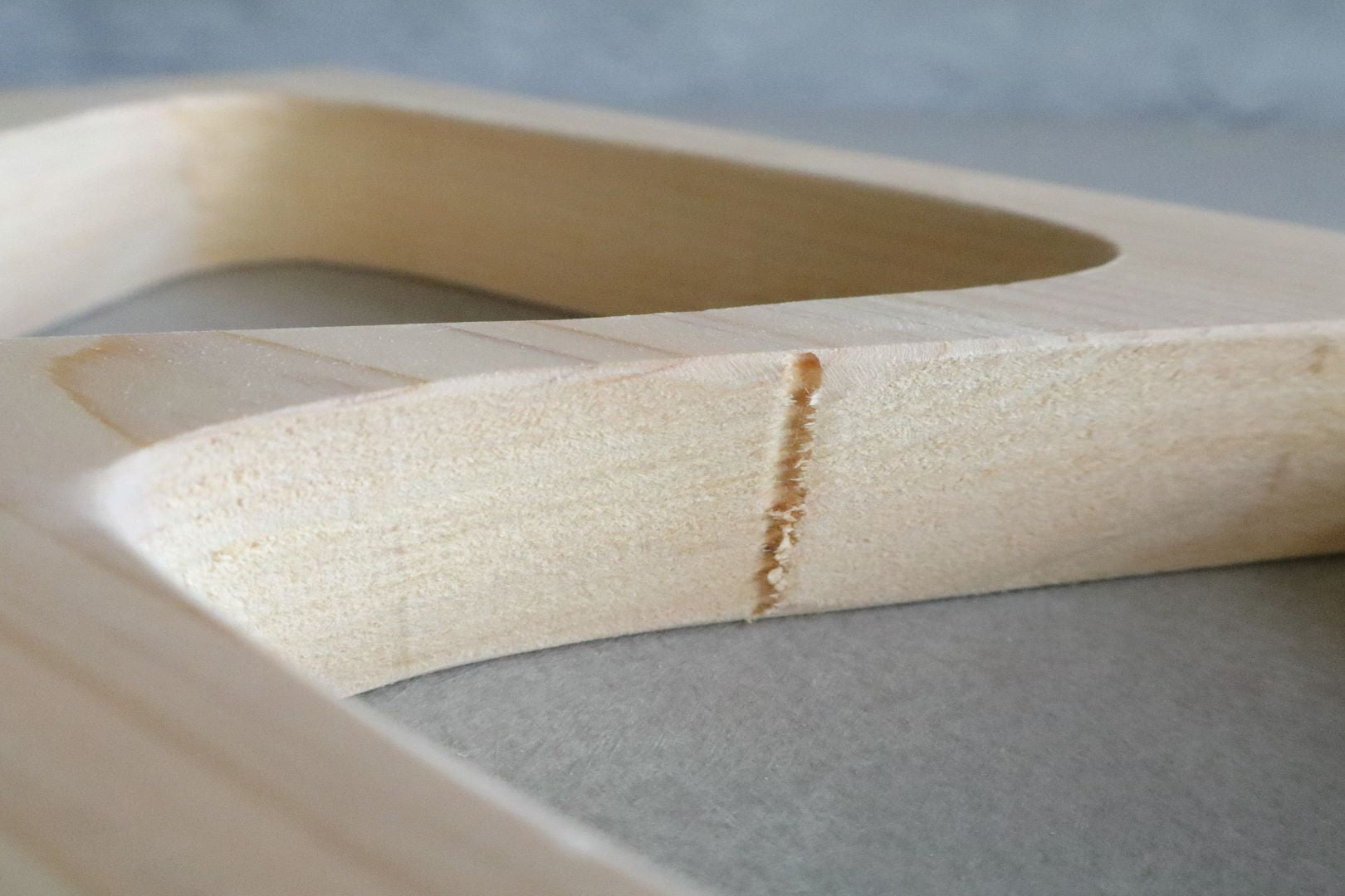 Close-up shot of the craftsmanship detailing on the Hinoki wood onigiri mold, showing natural wood grain and texture.