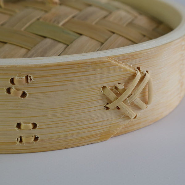 Close-up detail of rattan fasteners securing the bamboo side of a seiro steam basket, showcasing the craftsmanship.