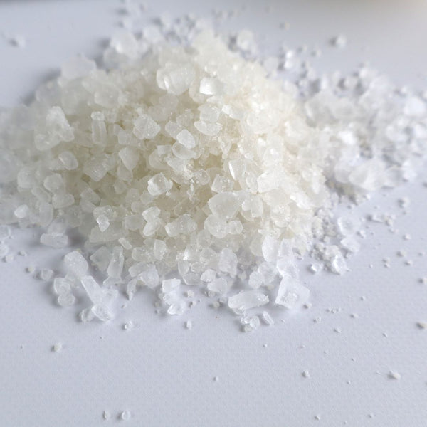 Close-up image of coarse bath salt crystals for Yuzu Bath Salt, highlighting the natural texture and appearance of the salt grains.