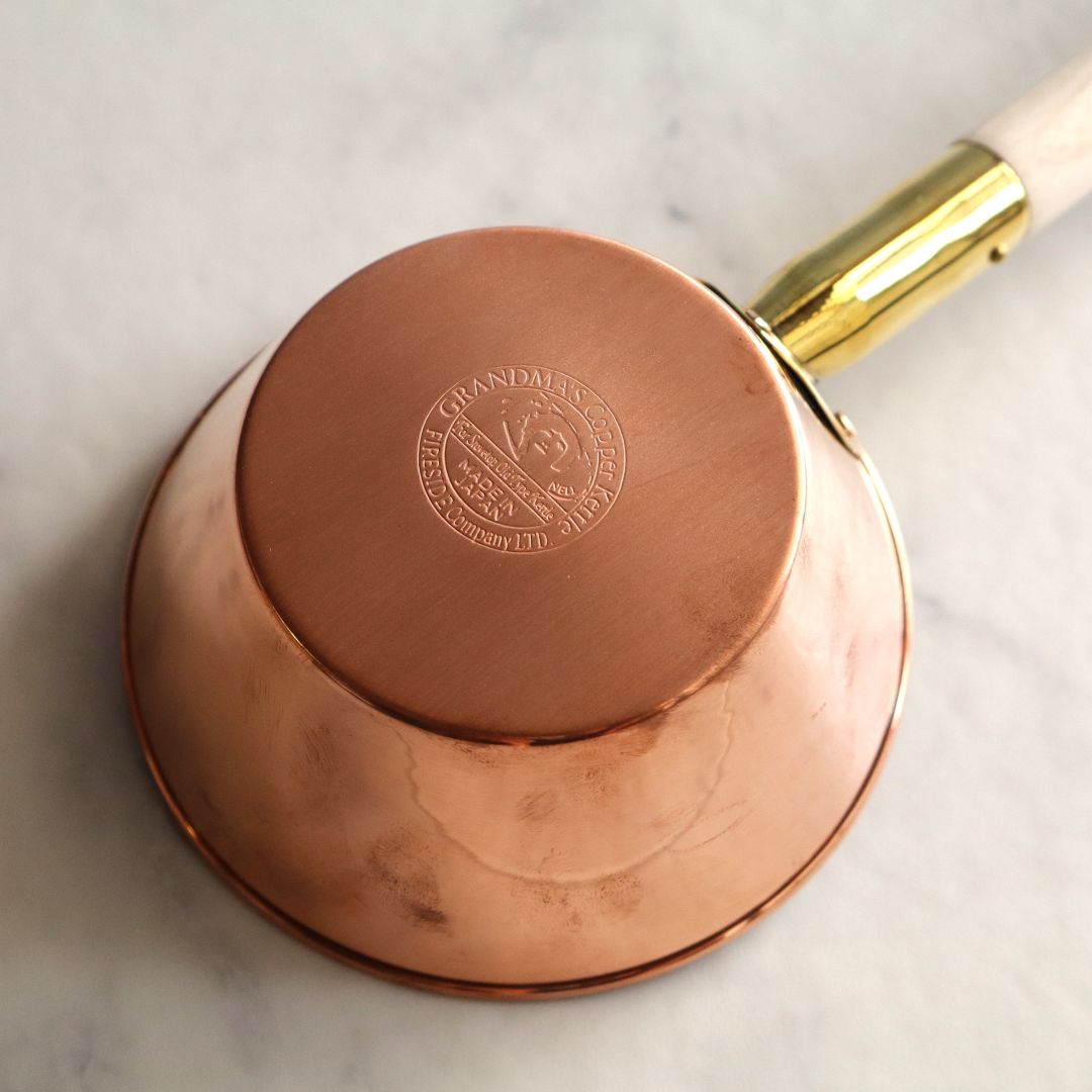 Close-up of the engraved mark on a Japanese-made copper sauna ladle, showcasing its quality craftsmanship.