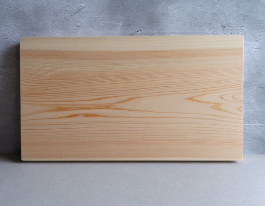 A top-down view of a high-quality cutting board made from a single slab of Shimanto Hinoki, showcasing its smooth surface and natural wood pattern.