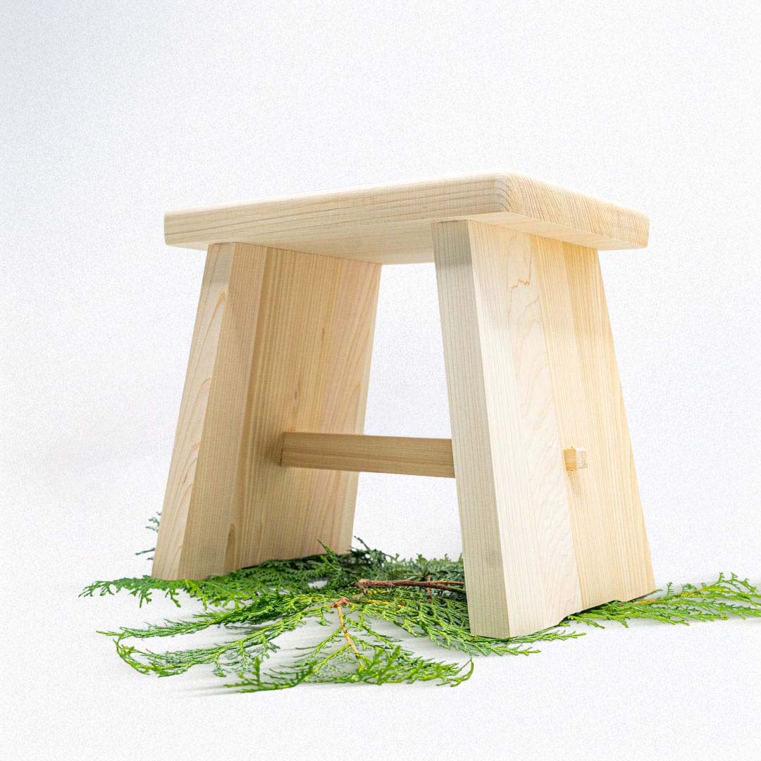 A Japanese wooden bath stool on top of green leaves