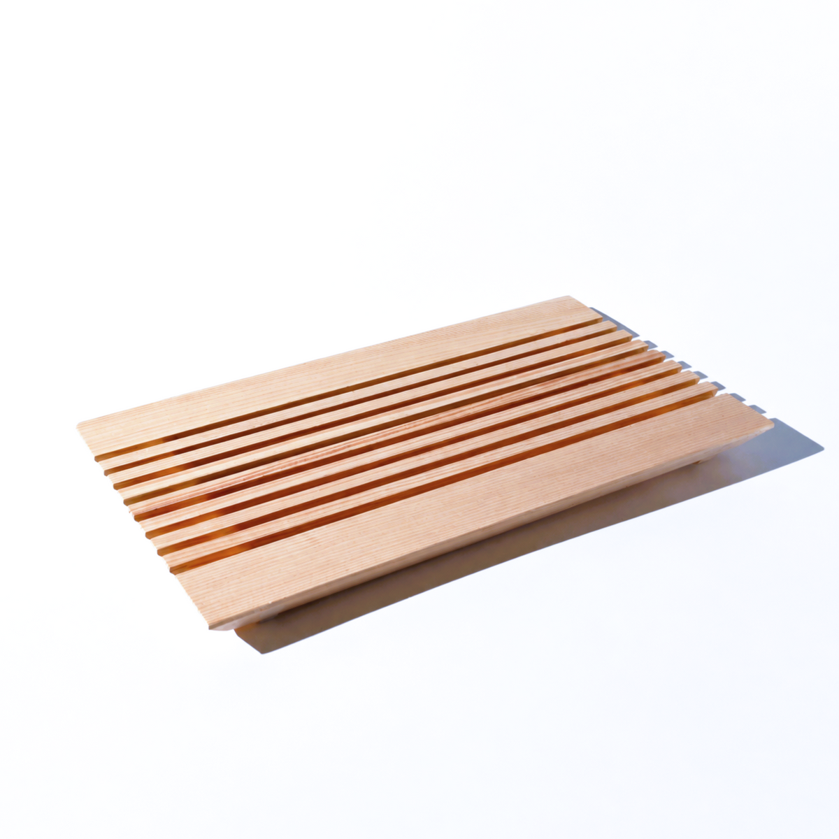 Wooden footrest with slatted design on a white background