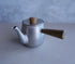 A compact Japanese-style teapot made of stainless steel with a side wooden handle and wooden knob on the lid
