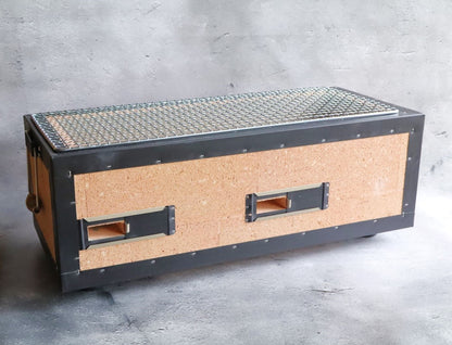 A side view of a Japanese rectangular hibachi grill featuring cork insulation and metal framing with a wire grilling surface.