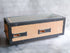 A side view of a Japanese rectangular hibachi grill featuring cork insulation and metal framing with a wire grilling surface.