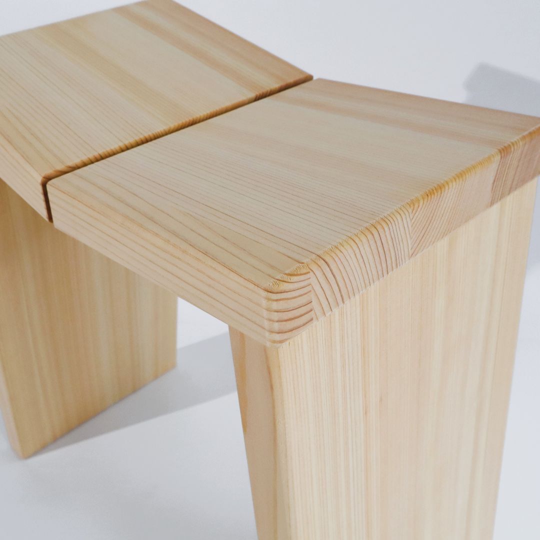 Wooden stool with a light finish on a white background
