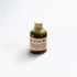 Bottle of matcha green tea bath essence on a white background