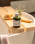 Matcha bottle on a wooden tray over a bathtub