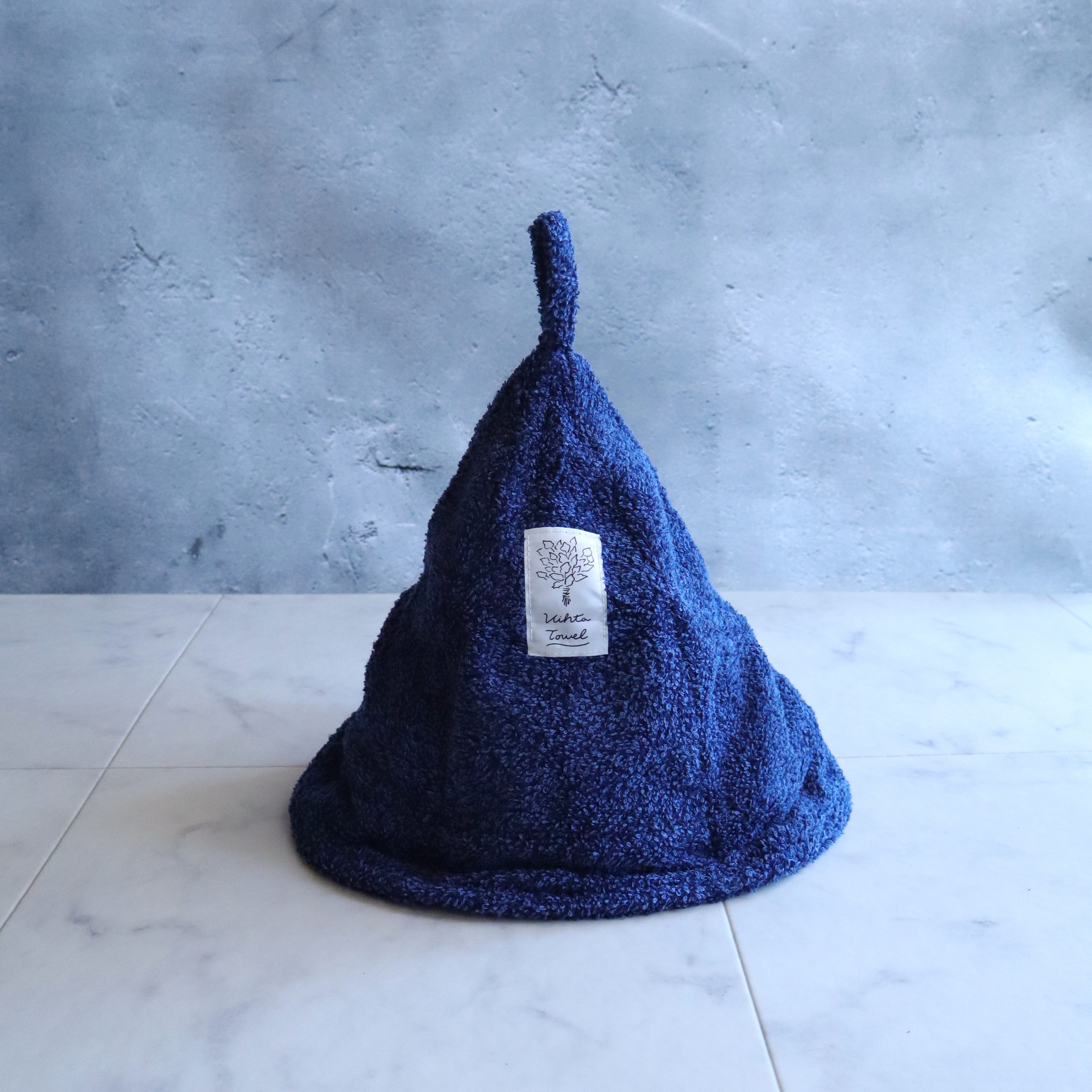 Tall, slightly oversized navy sauna hat made from cotton-rayon (birch fiber blend) with a loop on top.