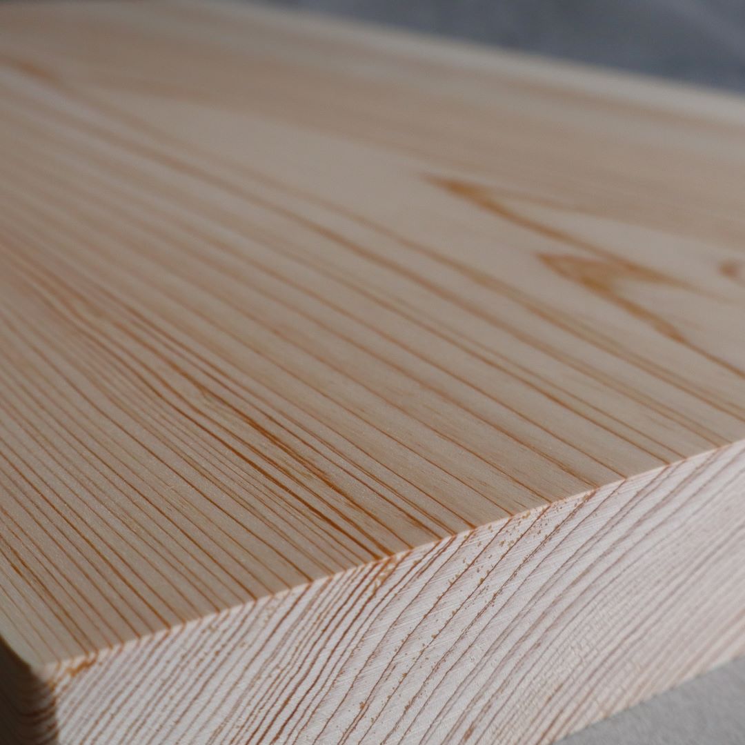 A close-up view of the fine wood grain on a premium cutting board made from a single slab of Shimanto Hinoki wood.