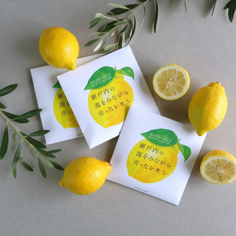 Three packets of Setouchi Lemon Bath Salt displayed with fresh lemons and green leaves on a neutral background.