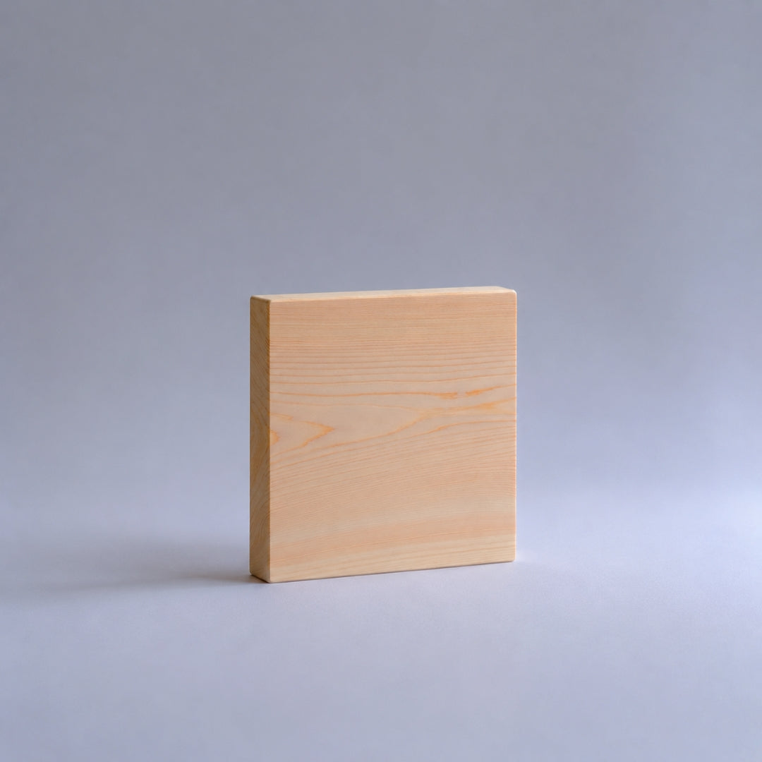 Square piece of wood on a gray background