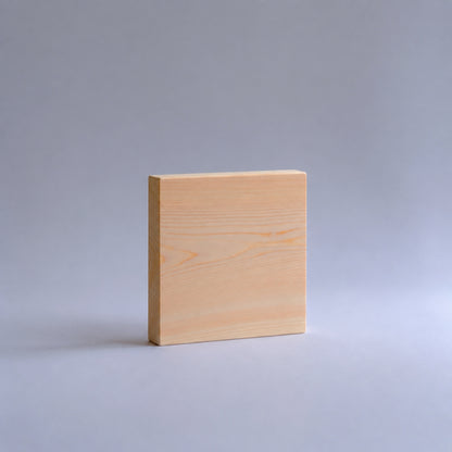 Square piece of wood on a gray background
