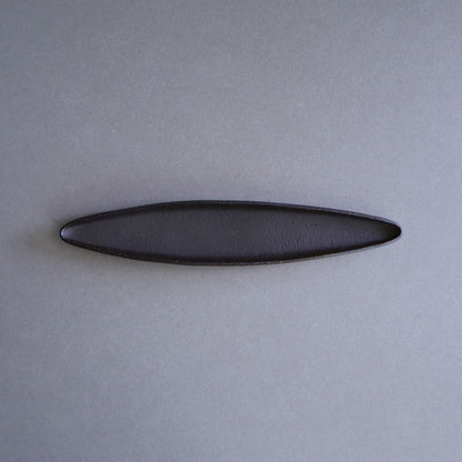 Black oval object on a gray background