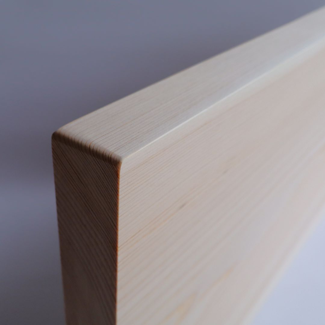 A top view of a premium cutting board made from Shimanto Hinoki, emphasizing the even wood grain and craftsmanship of the single slab.