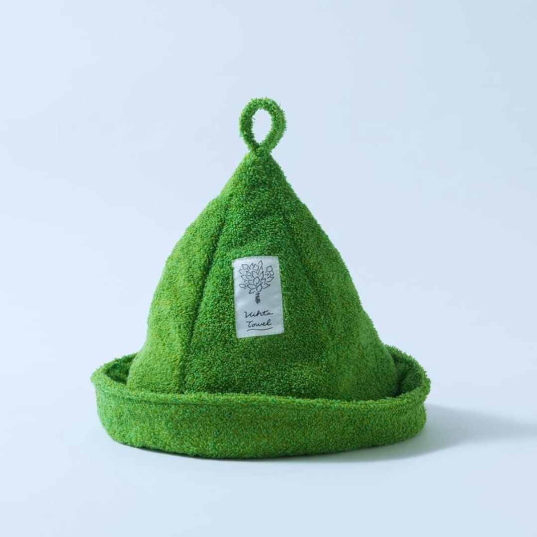 Green textured towel shaped like a cone with a brand label on a light blue background
