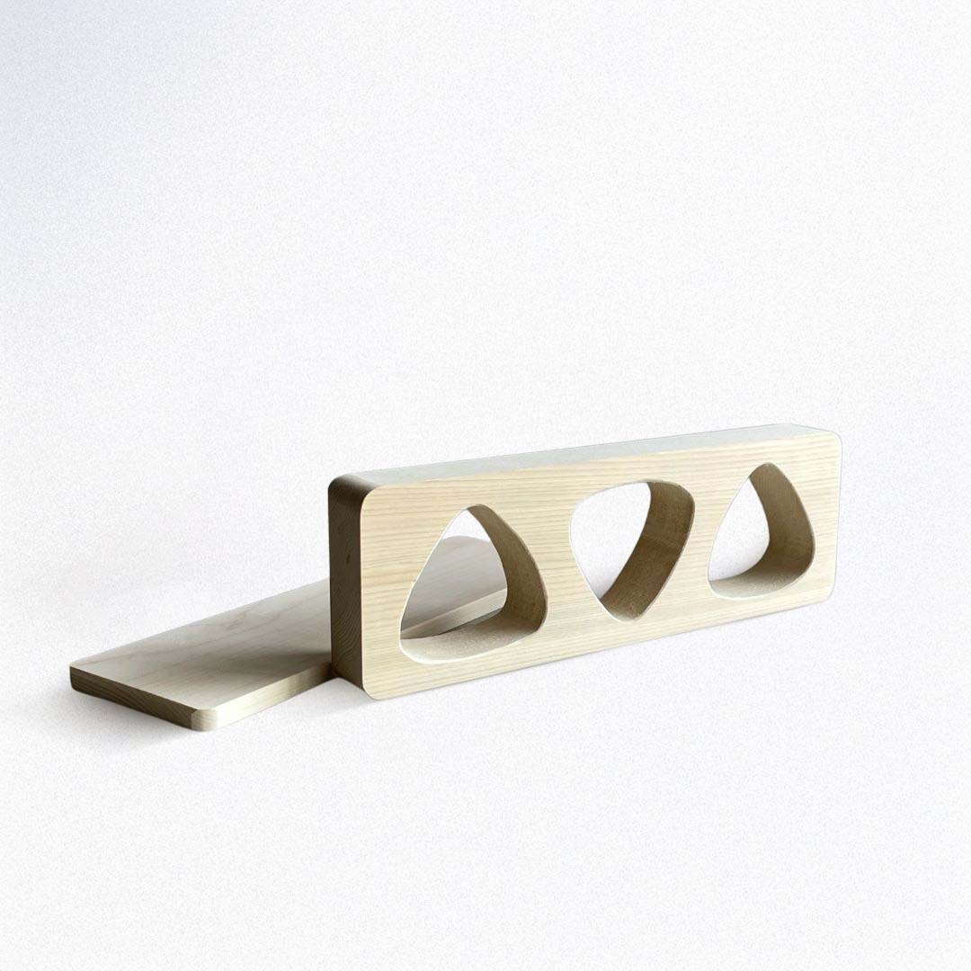 Wooden block with three circular holes on a white background